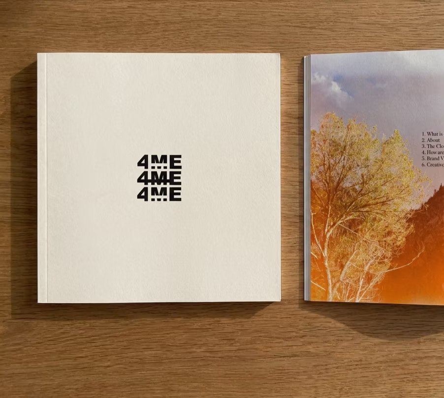 The 4ME NOTU biography: a bone cover stamped 4ME 4ME 4ME beside an open autumn spread.